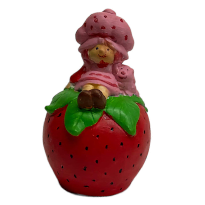 Girl Sitting on Strawberry Statue Ready to Paint Plaster Mold